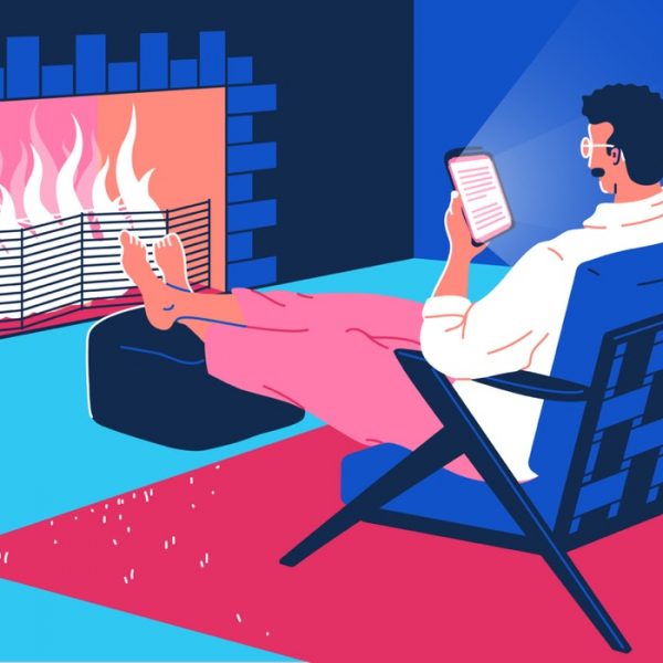 mixkit-man-sitting-in-front-of-a-fire-reading-from-a-66-original-large.jpg